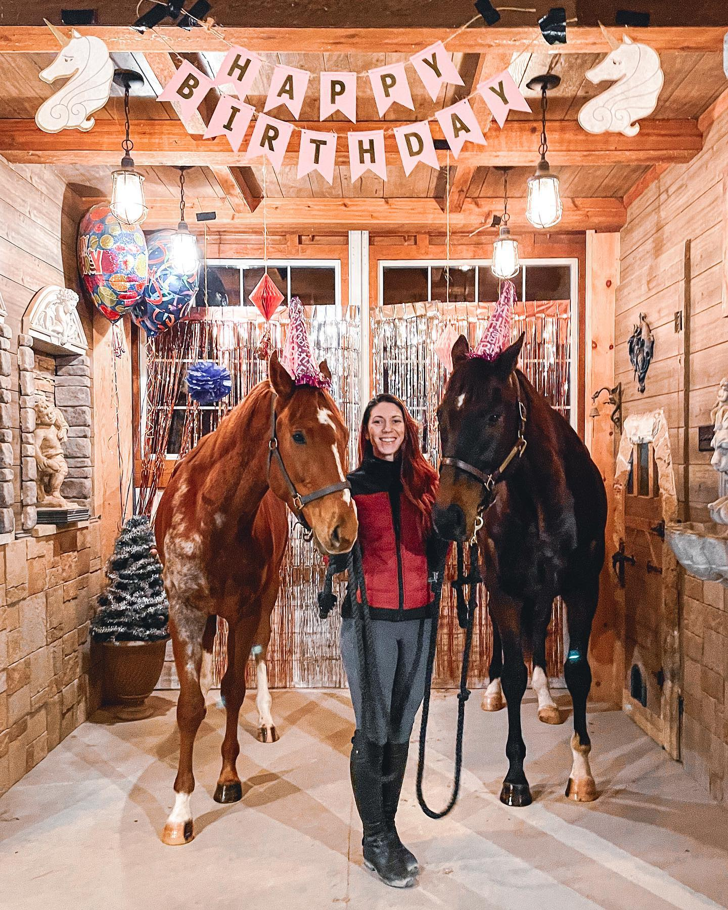 Jessica Darby Birthday photo with a chestnut horse and dark bay horse with birthday hats on